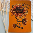 Orange hardcover journal with illustrated cover design and decorative accents