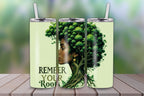 Tumbler with Afro-tree design and 'Remember Your Roots' text, featuring a powerful Black woman with natural hair styled as a forest. Printed on 20oz stainless steel drinkware."
