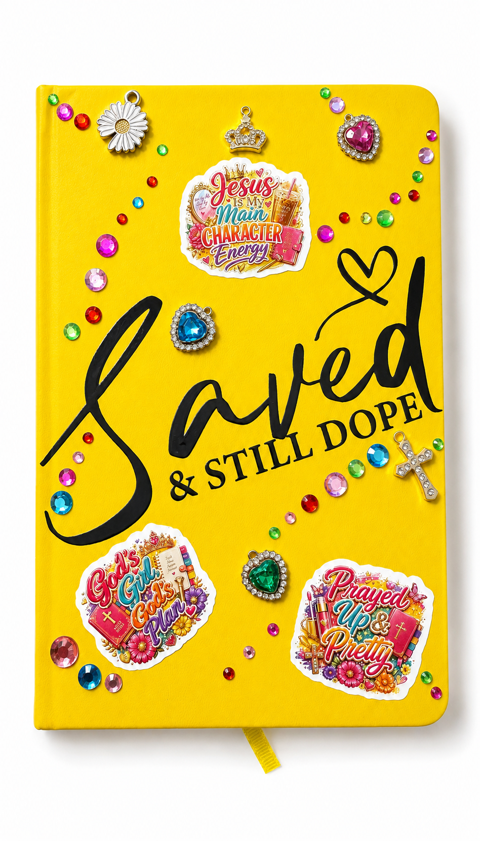 Bright yellow Saved & Still Dope vegan 366-page faith journal with colorful gems, Christian stickers, charm accents, and blue rhinestone pen.