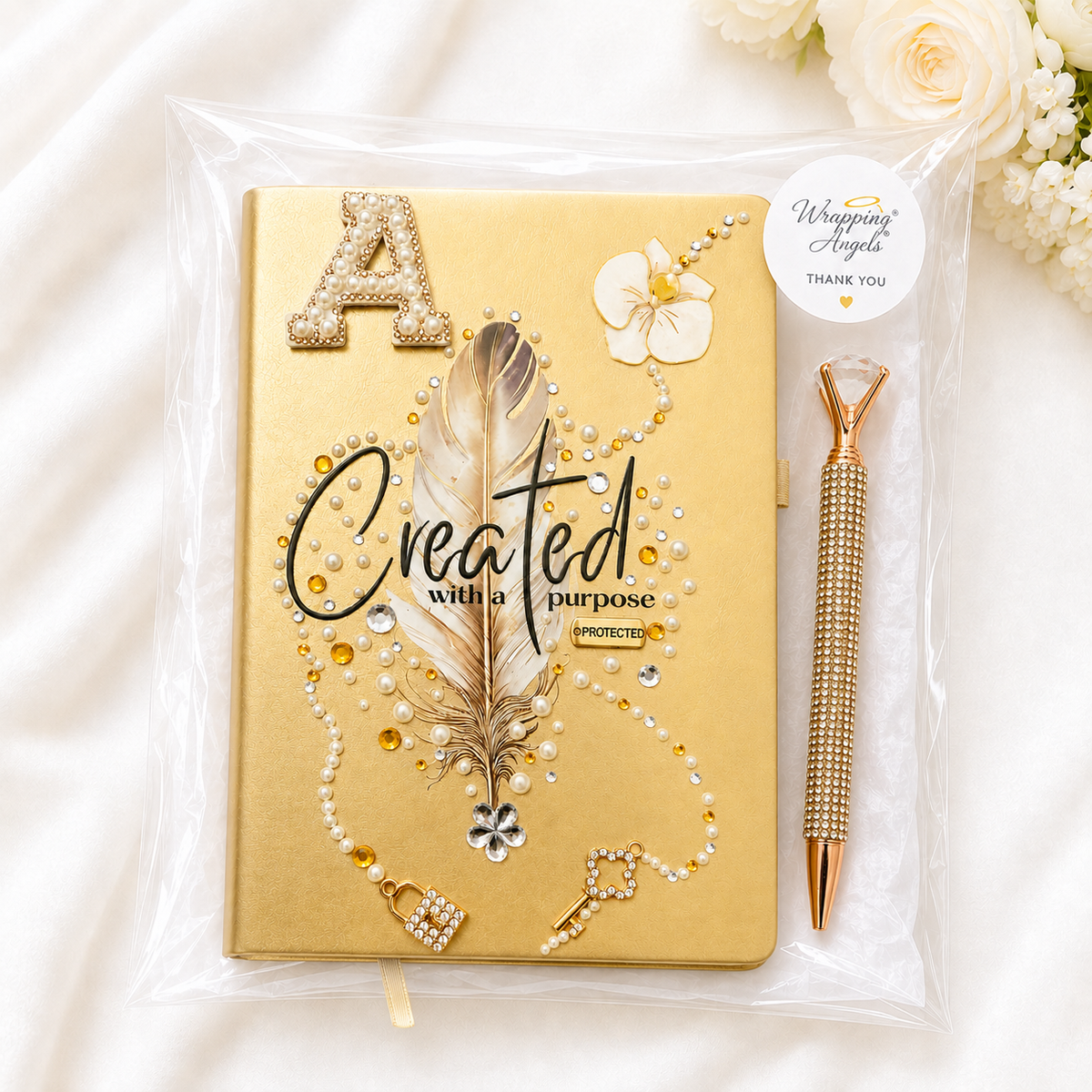 Covered in Grace Christian journal with a warm gold cover, jeweled feather, pearls, floral accents, and matching pen