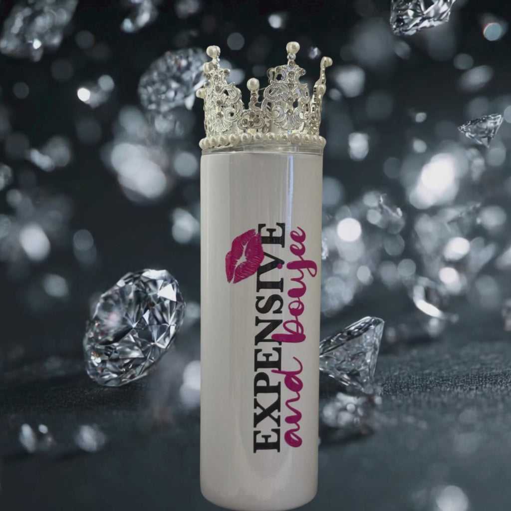 Expensive and Boujee 20oz tumbler with gold crown lid and bold lettering, luxury diamonds in background.”