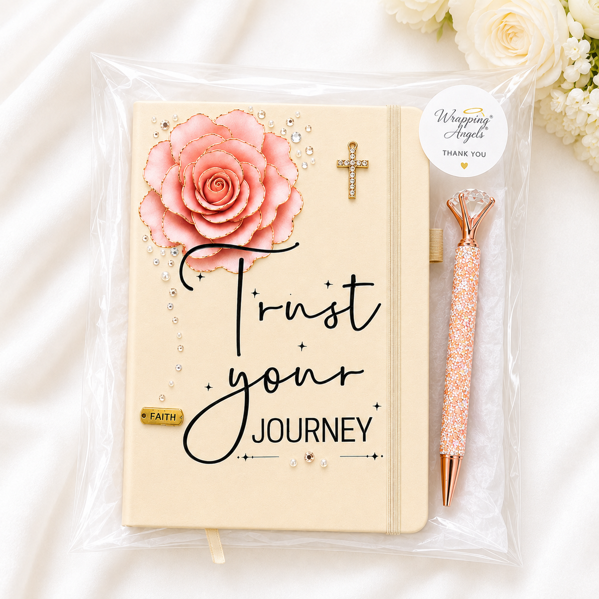 Trust Your Journey journal in cream with a blush layered rose, gold cross, rhinestone accents, and matching pen